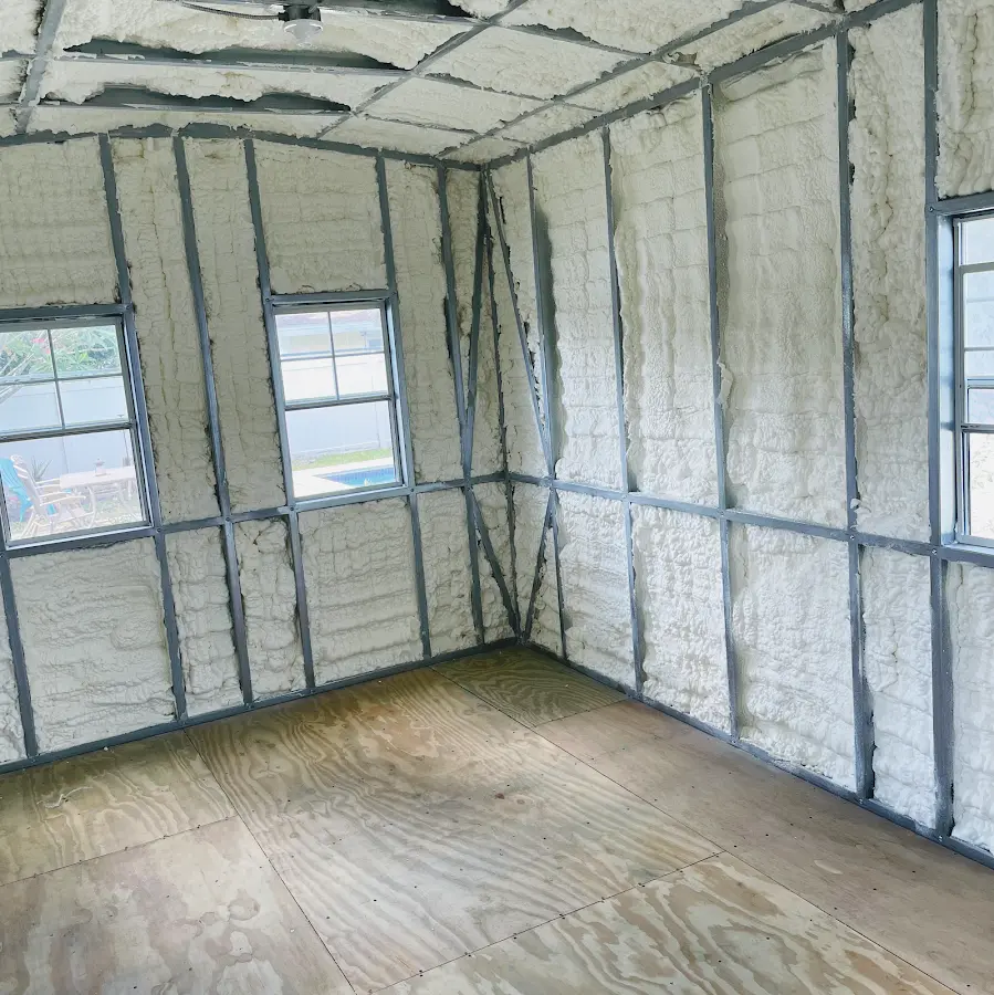 Closed-cell spray foam insulation applied to wall cavities in a residential project in Manalapan